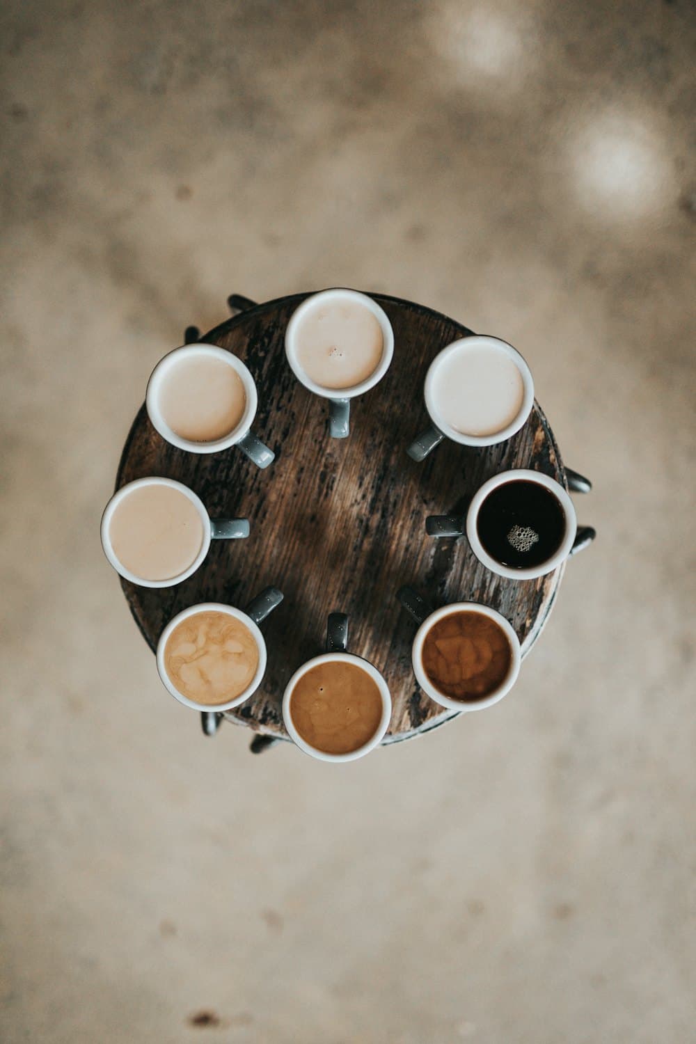Overhead view of coffee cups arranged around a round table