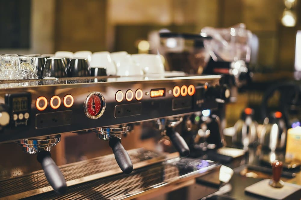 A chrome espresso machine glowing in soft light
